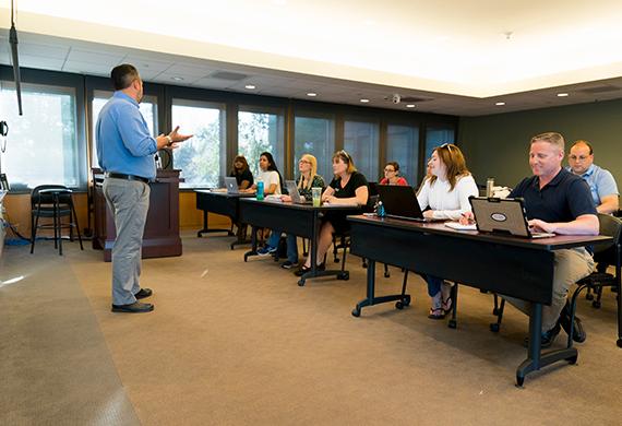 Image of adult students during a classroom discussion.